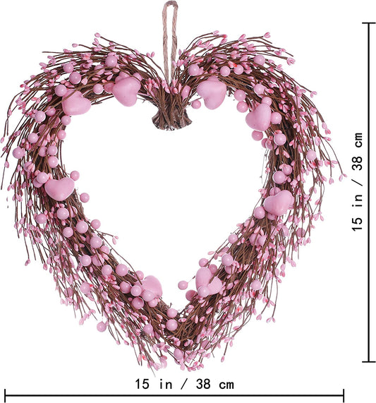 artificial heart-shaped wreath with pink hearts and berries